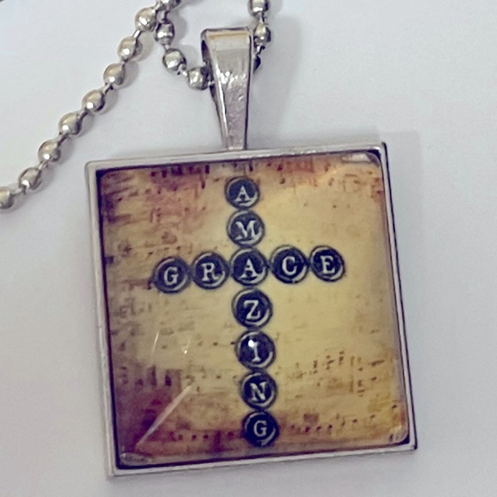 Amazing Grace cross necklace 23” chain 1” square pendant w/ clear dome front.